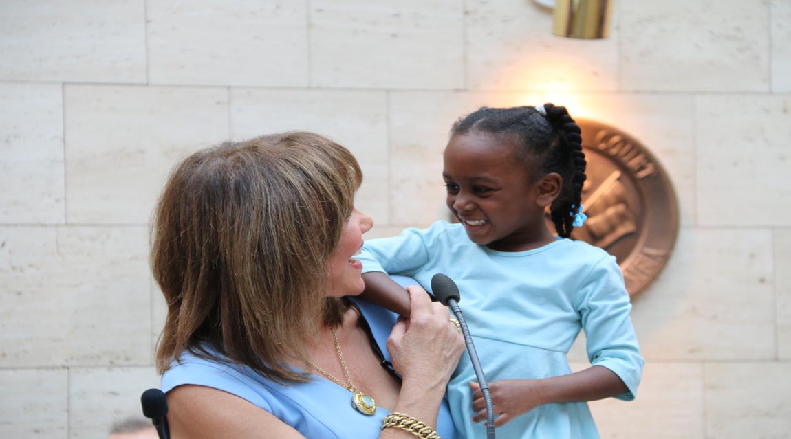Barbara Harrison Holding a Child